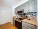 Kitchen featuring updated stainless steel appliances and stone countertops with colorful backsplash at 212 Overlook Dr, Winter Haven, FL 33884