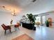 Open concept living and dining room with tile floors, light gray walls, chandelier and neutral decor at 212 Overlook Dr, Winter Haven, FL 33884