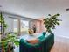 Spacious living room featuring light gray tile flooring, ample natural light, and stylish furnishings at 212 Overlook Dr, Winter Haven, FL 33884