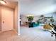 Bright and airy living room with light gray tile, and an open floor plan leading to dining area at 212 Overlook Dr, Winter Haven, FL 33884