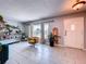 Bright and airy living room with light gray tile floors, an accent chair and open-concept design at 212 Overlook Dr, Winter Haven, FL 33884