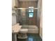 Cozy bathroom featuring a shower and tub combination with a glass enclosure, neutral colored walls and tile flooring at 2748 Cr 543, Sumterville, FL 33585