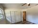 This is a view of the bedroom, including an overhead fan and a closet with white folding doors at 2748 Cr 543, Sumterville, FL 33585