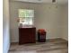 The bedroom has wood floors, a window, and a dark wooden dresser at 2748 Cr 543, Sumterville, FL 33585