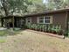 Charming single-story home with brown exterior, manicured landscaping, and neutral trim around the windows at 2748 Cr 543, Sumterville, FL 33585