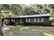Charming single-story home with brown exterior, covered carport, well maintained landscaping, and a metal roof at 2748 Cr 543, Sumterville, FL 33585