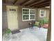 Inviting front porch with charming decor, seating area, and decorative door with a window at 2748 Cr 543, Sumterville, FL 33585