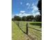 Fenced land with a grassy field and mature trees in the background at 2748 Cr 543, Sumterville, FL 33585