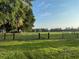 The expansive property features a pasture with mature trees and fencing at 2748 Cr 543, Sumterville, FL 33585