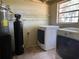 This laundry room contains a new washer and dryer, and a water softener at 2748 Cr 543, Sumterville, FL 33585