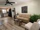 Open-concept living room with neutral colors, updated flooring, stylish furnishings and seamlessly connects to the kitchen at 2748 Cr 543, Sumterville, FL 33585