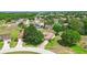 Aerial view of a home within a community surrounded by mature trees at 413 Bay Leaf Dr, Poinciana, FL 34759