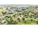 Community aerial view of houses with lush trees, roads, and green spaces creating an attractive residential landscape at 413 Bay Leaf Dr, Poinciana, FL 34759