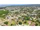 Expansive aerial view of a residential community, a lake, and green spaces at 413 Bay Leaf Dr, Poinciana, FL 34759
