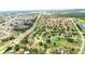 An aerial view captures a vibrant community with neat rows of houses and lush green spaces divided by roadways at 413 Bay Leaf Dr, Poinciana, FL 34759