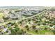 Aerial view showcasing a home with lush trees, roads, and green spaces within an attractive residential landscape at 413 Bay Leaf Dr, Poinciana, FL 34759