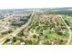 Aerial view showcasing a home within a community, complete with roads, green spaces, and nearby amenities at 413 Bay Leaf Dr, Poinciana, FL 34759