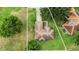 A bird's eye view of a house with a landscaped yard, tile roof, and adjacent properties marked by boundary lines at 413 Bay Leaf Dr, Poinciana, FL 34759