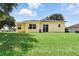 Well-maintained home with a large backyard and a tiled roof at 413 Bay Leaf Dr, Poinciana, FL 34759