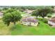 Aerial view of a yellow single-Gathering home with a tile roof and a spacious, well-maintained backyard at 413 Bay Leaf Dr, Poinciana, FL 34759