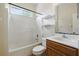 Clean bathroom features a shower-tub combination, a vanity, and open shelving at 413 Bay Leaf Dr, Poinciana, FL 34759