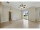 Bright bedroom featuring tile floors, a ceiling fan, a sliding door, and neutral paint that complements the natural light at 413 Bay Leaf Dr, Poinciana, FL 34759
