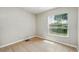A quaint bedroom with light walls, a window, and tiled flooring at 413 Bay Leaf Dr, Poinciana, FL 34759