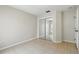 A simple bedroom featuring tiled flooring and a mirrored sliding door closet at 413 Bay Leaf Dr, Poinciana, FL 34759