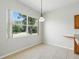 Dining area features tile flooring and large window with backyard view at 413 Bay Leaf Dr, Poinciana, FL 34759
