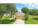 Charming single-story home with a well-manicured lawn and mature trees at 413 Bay Leaf Dr, Poinciana, FL 34759