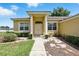 Charming single story home featuring a symmetrical facade, double door entry, and low maintenance landscaping at 413 Bay Leaf Dr, Poinciana, FL 34759
