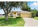 Charming single-story home with a well-manicured lawn and mature trees at 413 Bay Leaf Dr, Poinciana, FL 34759