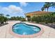 Relaxing hot tub with bubbling water next to the community pool surrounded by lush greenery at 413 Bay Leaf Dr, Poinciana, FL 34759