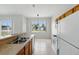 Open kitchen features a breakfast bar, tile flooring, and updated appliances at 413 Bay Leaf Dr, Poinciana, FL 34759