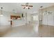 Expansive living area with an open layout, tile flooring, and a view into the kitchen for easy entertaining at 413 Bay Leaf Dr, Poinciana, FL 34759