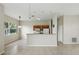 Open-concept living area featuring tile flooring, neutral paint, and an eat-in kitchen with modern appliances at 413 Bay Leaf Dr, Poinciana, FL 34759