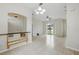 Open-concept living area with neutral paint, tile flooring, and a seamless flow between the living and dining spaces at 413 Bay Leaf Dr, Poinciana, FL 34759