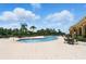 Resort-style community pool with tiled deck, palm trees and ample seating under sunny skies at 413 Bay Leaf Dr, Poinciana, FL 34759