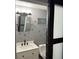 Updated powder room featuring stylish vanity, modern lighting, unique dragonfly themed decor and soft gray walls at 609 Linnet Ct, Poinciana, FL 34759