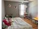 Cozy bedroom with wood floors, a ceiling fan, a bookshelf, and soft decor for a  at 609 Linnet Ct, Poinciana, FL 34759