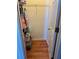Walk-in closet with wooden floors and hanging storage with shelf with clothes at 609 Linnet Ct, Poinciana, FL 34759