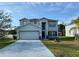 Charming two-story home with a well-maintained lawn and landscaping at 609 Linnet Ct, Poinciana, FL 34759