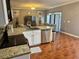 Open-concept kitchen featuring granite countertops and stainless steel appliances at 609 Linnet Ct, Poinciana, FL 34759