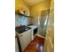 Functional laundry room with washer, dryer, storage shelf and window for natural light at 609 Linnet Ct, Poinciana, FL 34759
