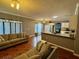 Spacious living room with a cozy sofa and an open floor plan to the kitchen and hardwood flooring at 609 Linnet Ct, Poinciana, FL 34759