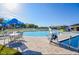 Community pool with bright blue umbrellas, a clear sky, and a splash pad at 609 Linnet Ct, Poinciana, FL 34759