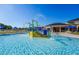 Community splash pad with a blue slide and climbing area next to the pool at 609 Linnet Ct, Poinciana, FL 34759