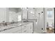 Modern bathroom featuring double sink vanity with granite countertop and walk-in glass shower at 112 Cr 532B, Bushnell, FL 33513