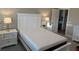Bedroom with white furniture including a queen bed with white headboard and two side tables at 112 Cr 532B, Bushnell, FL 33513