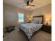 This cozy bedroom includes a ceiling fan and window with plantation shutters for natural light at 112 Cr 532B, Bushnell, FL 33513